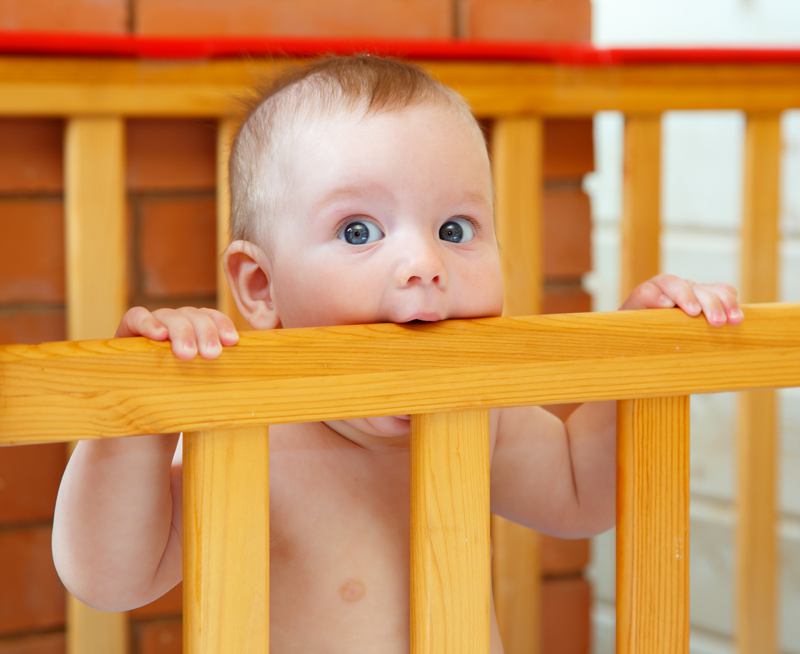 Baby peeping over crib