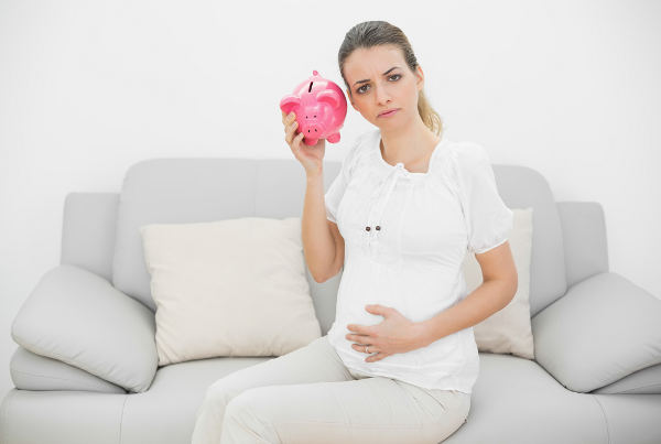 Pregnant Woman With Empty Piggy Bank