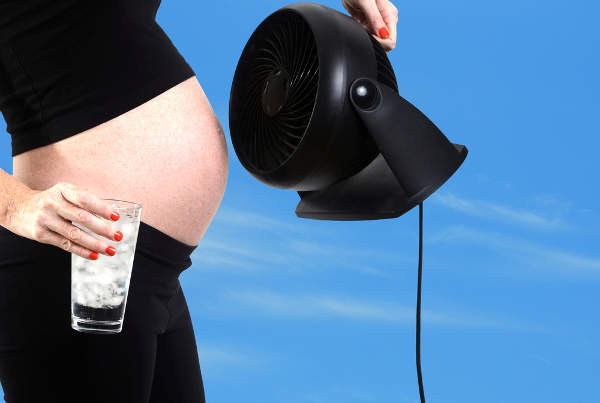 Pregnant woman with a fan