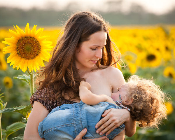 Happy woman breastfeeding baby