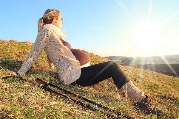 Pregnant woman rest in sunset