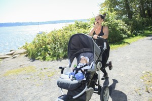 woman jogging with baby eating an apple
