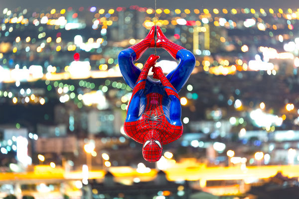 Spider-Man model upside down on cityscape background_EUO_ FUN FUN PHOTO-shutterstock