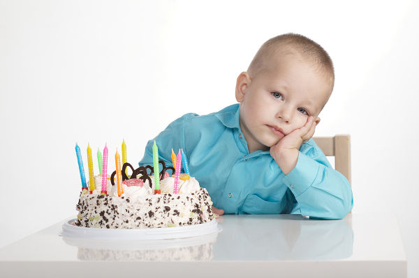 bored boy with birthday cake