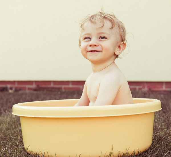happy little baby boy having fun in the bowl