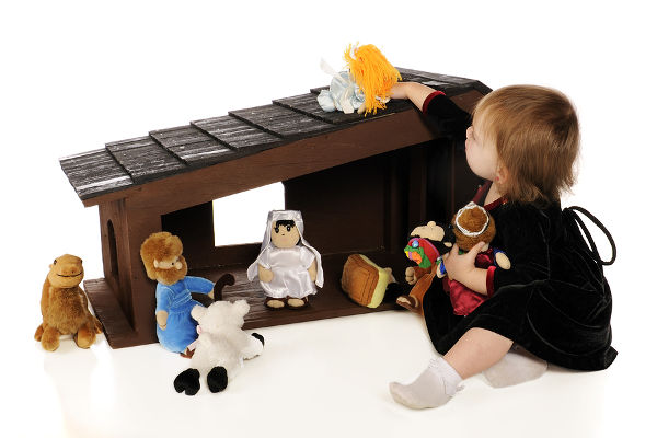 baby girl playing with a large _soft scuptured_ Nativity Set