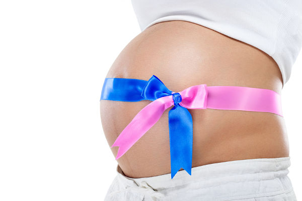 twins pregnancy, pregnant belly with blue and pink ribbon