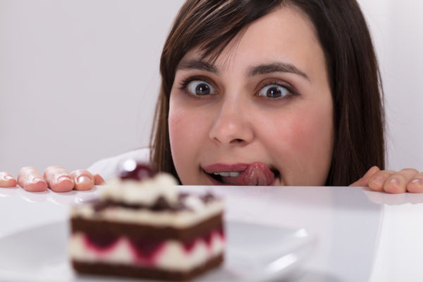 Young Woman Craving To Eat Slice Of Cake Licking Her Lips