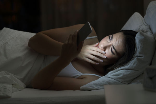 Woman on phone in bed