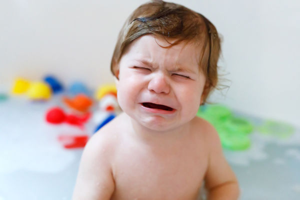 Toddler having tantrum in bath