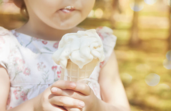 Little Girl Eating Ice-cream. Funny Child With Ice-cream Outdoor