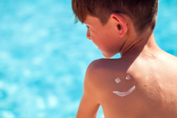Boy with suncream on his back