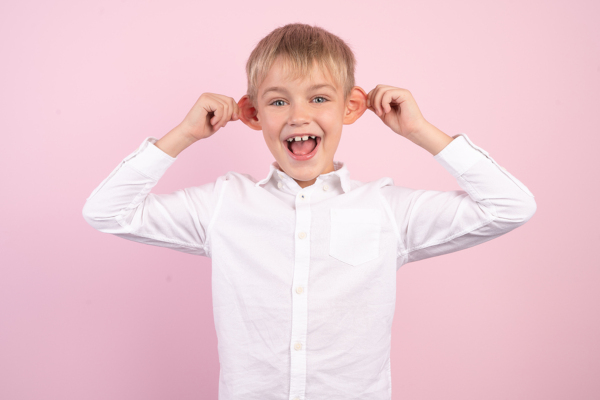 Portrait Of Happy Naughty Little Boy Bulging His Ears.