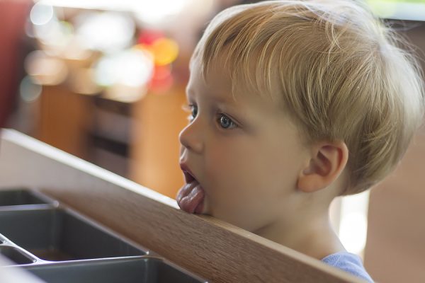 Kid licking the table