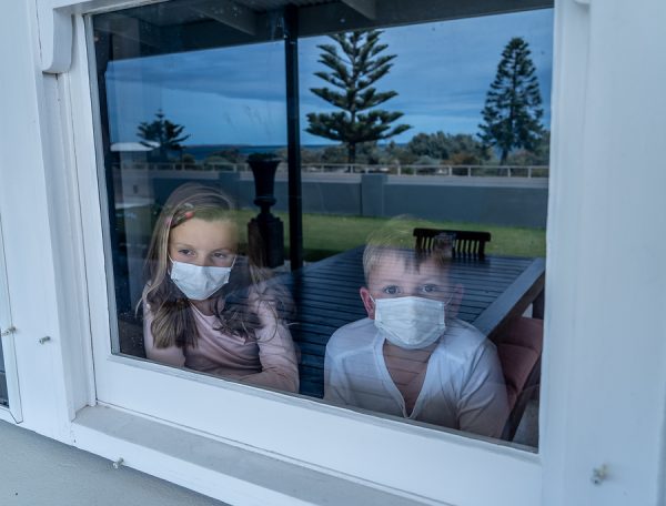 Covid-19 Quarantine. Sad Little Girl Looking Through The Window
