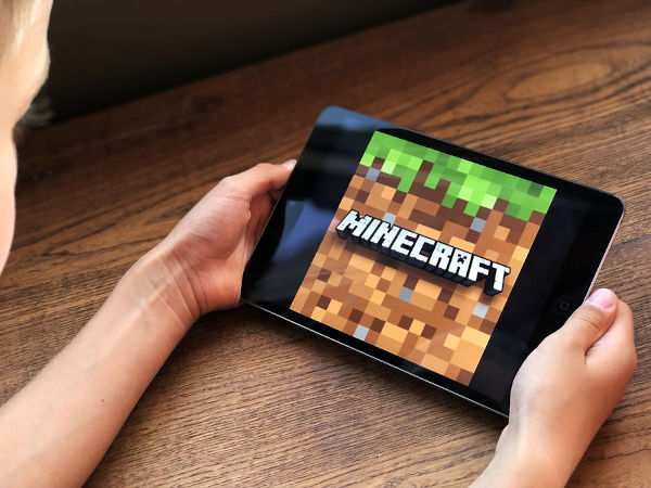 Boy playing Minecraft on a tablet