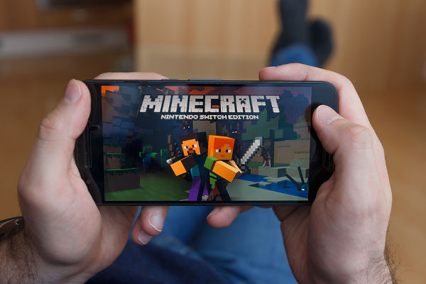 Man playing Minecraft on phone