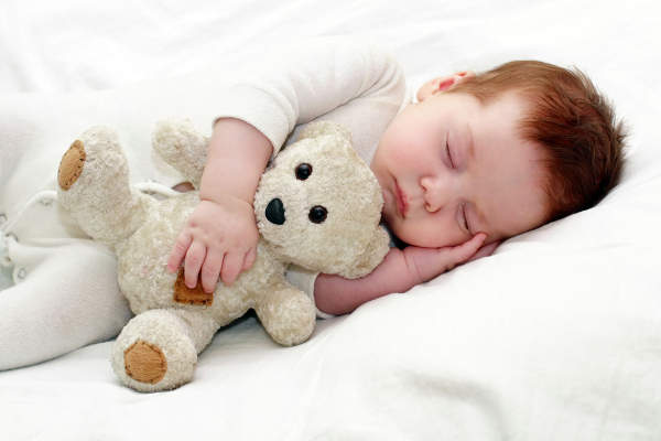 Baby sleeping with teddy