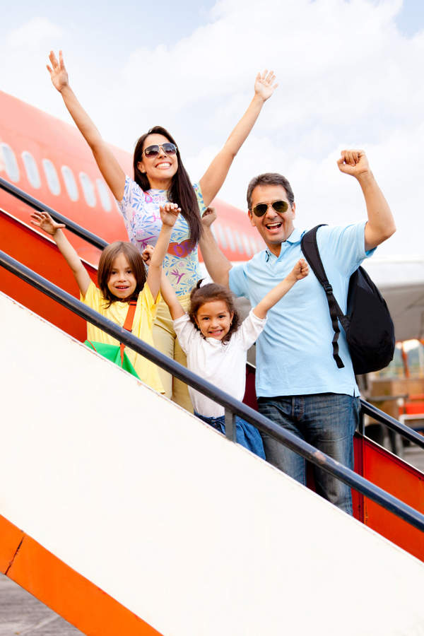 Family getting on plane for holiday
