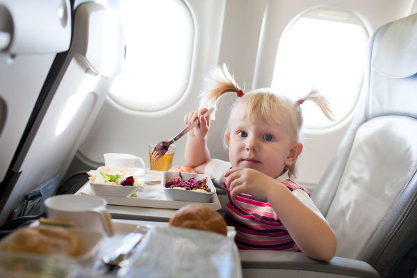 Toddler eating on plane