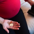 Pregnant woman with small money and empty wallet