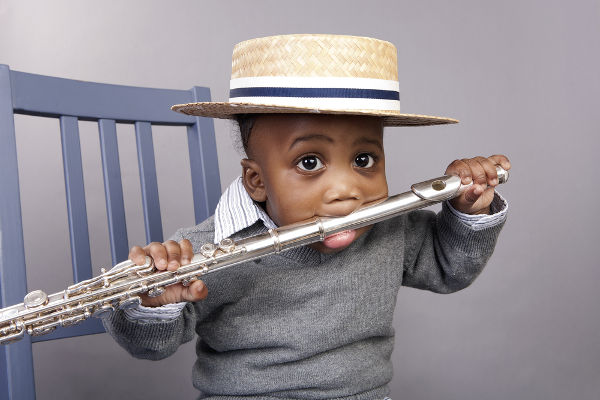 Baby boy with flute in his mouth