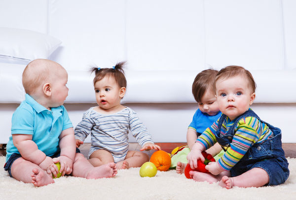 Admin_Four babies group sitting on the floor