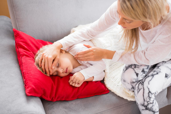 Mother with her sick kid at home