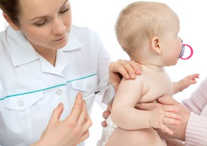 Doctor giving vaccination to baby