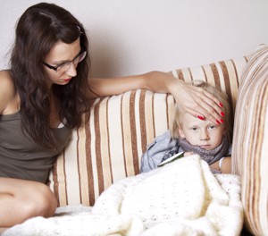 Mother feeling child's forehead