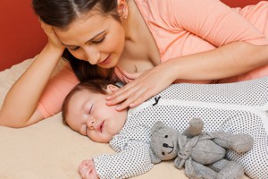 Mother watching baby sleep