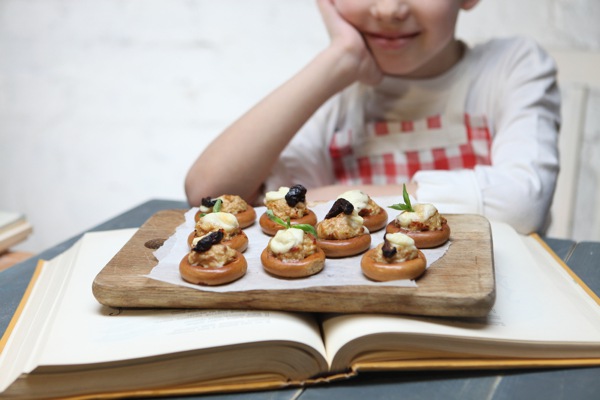 child with board of canapes