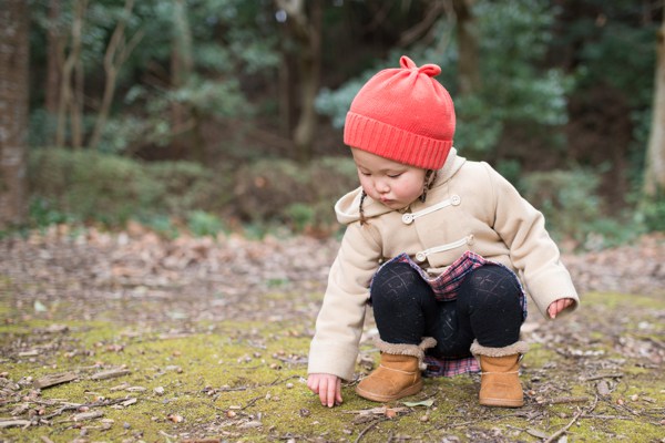 Child picking up acorns