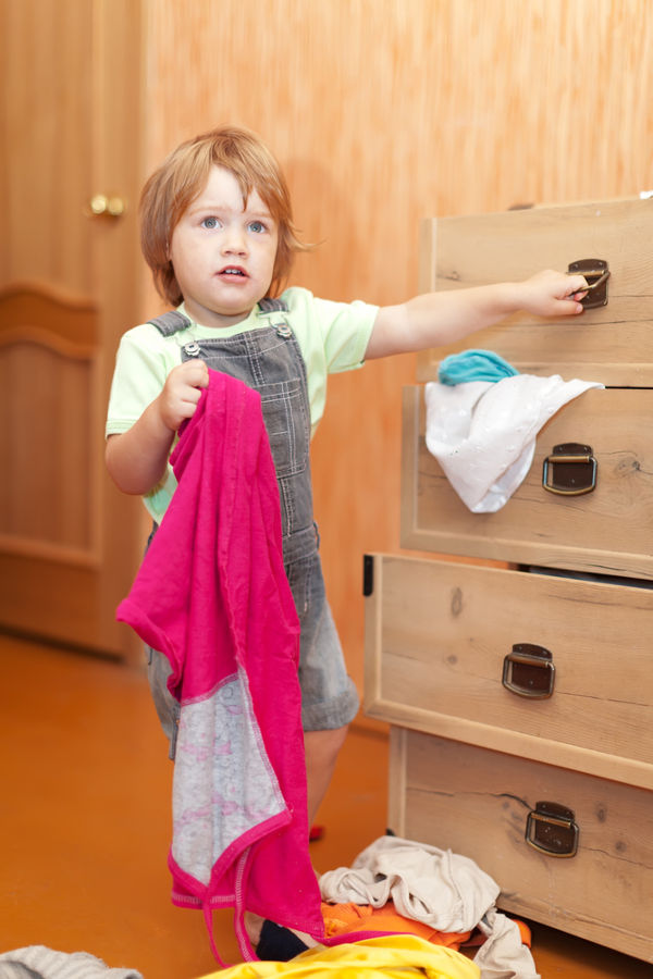 Baby girl at closet. She thinking what get dressed