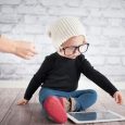 Mother helping her child with digital tablet