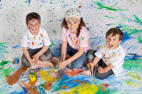 Children playing with painting with the background painted