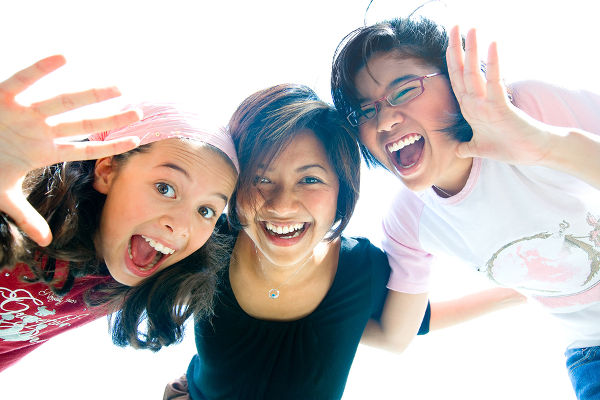 Family of three girls in fun expression playing together