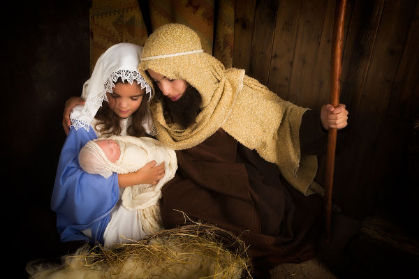 Christmas nativity scene reenacted by children and a doll