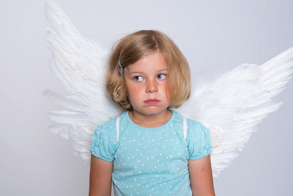 little blond girl with angel- wings is sad
