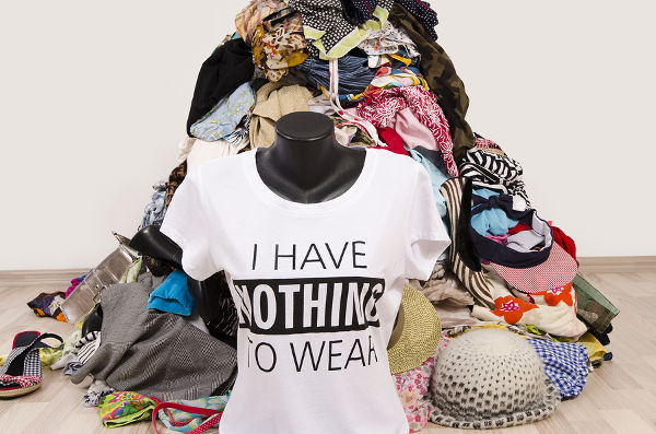 Untidy cluttered wardrobe with colorful clothes and accessories