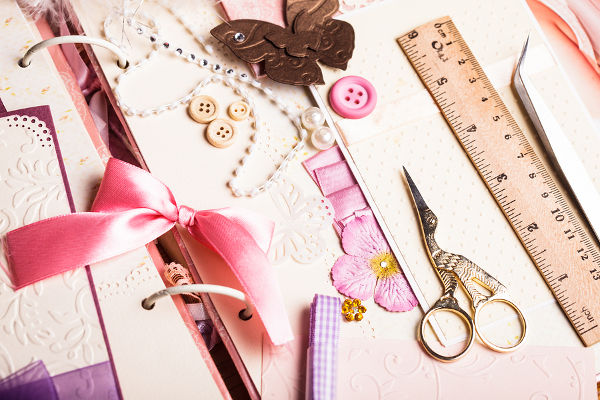 The making scrapbooking album with tolls and pink decorations