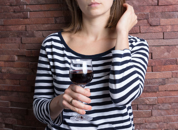 Girl holding a glass of red wine