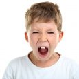 Portrait of emotional little boy on white background