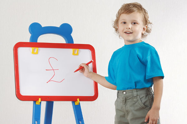 Little smiling boy drew pound sign on the whiteboard