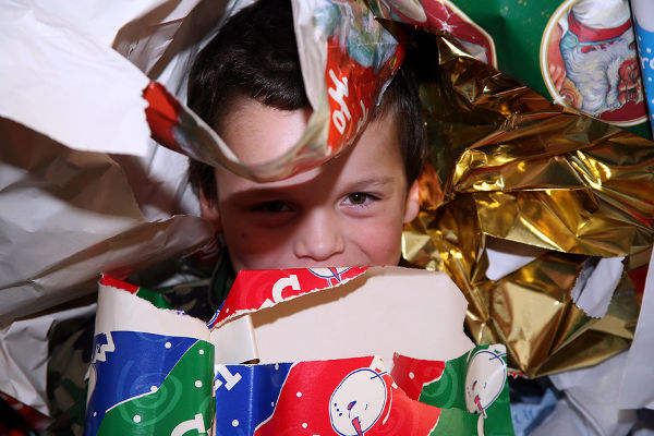 boy hiding in wrapping paper