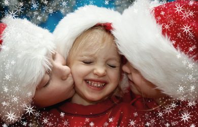 Children wearing Santa Claus hats and snowflake frame