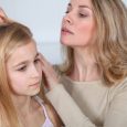 Mother treating daughter's hair against lice