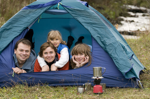 Happy family camping in tent