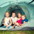 Children in a tent. Camping. Happy kids at summer vacations