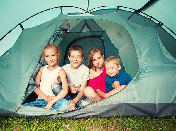 Children in a tent. Camping. Happy kids at summer vacations